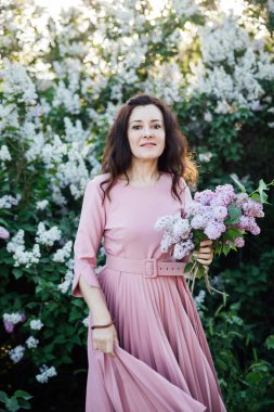 Leylak çiçekli güzel esmer kadın.