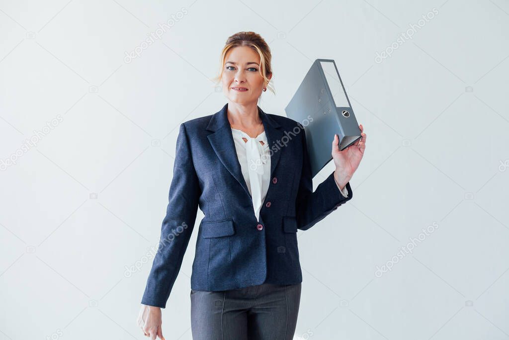 woman 40 years old with folders for papers in a white office