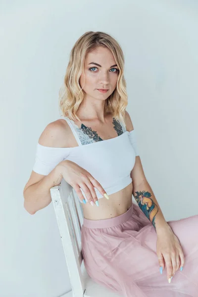 Portrait of a beautiful blonde woman in a light summer dress — Stock Photo, Image