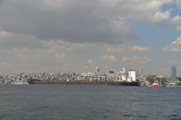 Bosphorus and Giant cargo ship passing through the Bosphorus on a sunny day. Istanbul, Turkey,