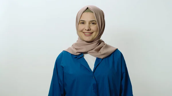 Happy and cheerful young woman in hijab laughing out loud. Woman posing in studio portrait isolated on white background. Portrait showing the feeling of shock or wow in the face of surprise.