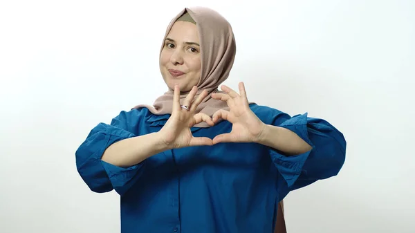 Gülümseyen Tesettürlü Kadın Beyaz Arka Planda Elleri Ile Kalp Şeklinde — Stok fotoğraf