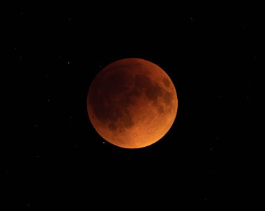 blood moon - fully eclipsed moon in starry black space