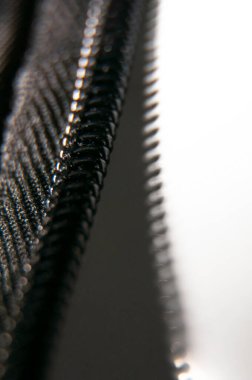Zipper making shadows. Black zipper opening