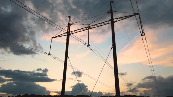 日没の電力線と高電圧タワーの暗いシルエット 電気の概念の移転 — ストック動画