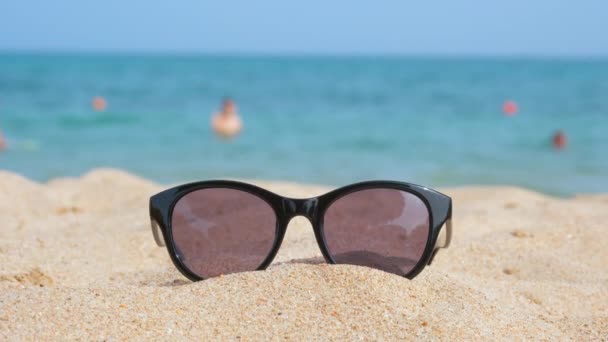 Closeup Black Protective Sunglasses Sandy Beach Tropical Seaside Warm Sunny — Stock Video