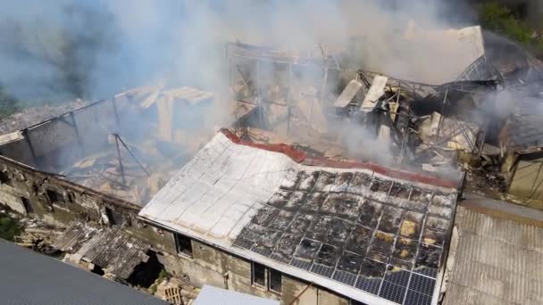 İtfaiyecilerin yıkık dökük çatısı ve yükselen kara dumanlı yangını söndürme görüntüsü. — Stok video