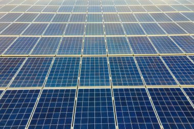 Mavi fotovoltaik güneş panellerinin yüzeyi, temiz ekolojik elektrik üretmek için çatıya monte edildi. Yenilenebilir enerji konsepti üretimi.