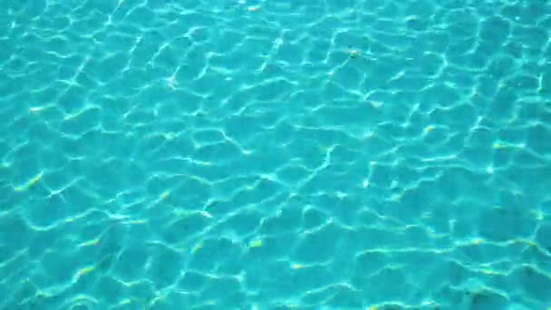 Крупним планом поверхня блакитної чистої води з невеликими пульсаційними хвилями в басейні — стокове відео