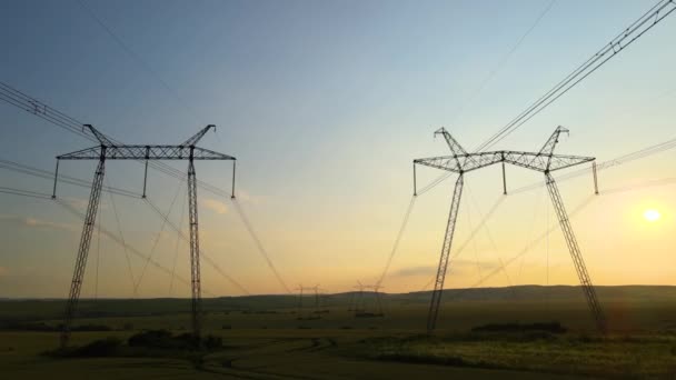 日の出時に電力線と高電圧塔の暗いシルエット. — ストック動画