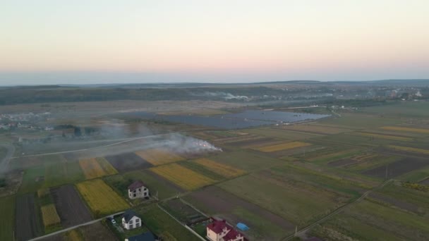 Aerial view of agricultural waste bonfires from dry grass and straw stubble burning with thick smoke polluting air during dry season on farmlands causing global warming and carcinogen fumes. — Stock Video