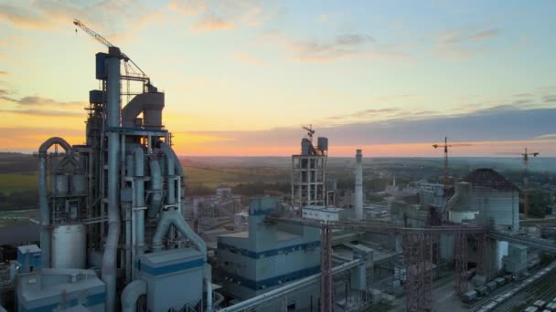 Aerial view of cement factory with high concrete plant structure and tower crane at industrial production area. Manufacture and global industry concept — Stock Video