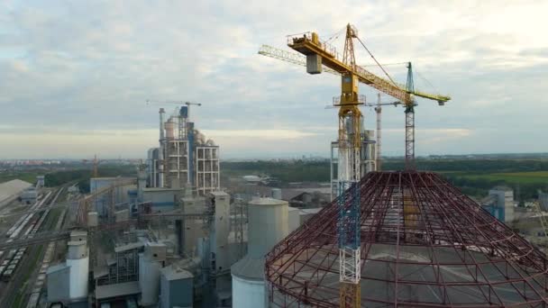 Vista aérea de la fábrica de cemento con alta estructura de planta de hormigón y grúa torre en el área de producción industrial. Fabricación y concepto de industria global — Vídeos de Stock