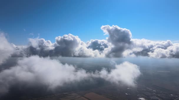 Vue aérienne depuis la fenêtre de l'avion à haute altitude couverte de cumulus gonflés se formant avant la tempête de pluie — Video