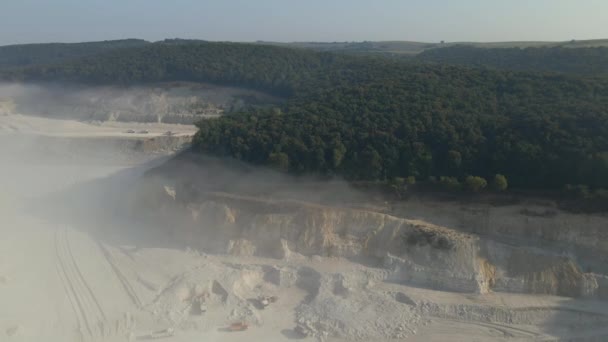 Aerial view of open pit mining of limestone materials for construction industry with excavators and dump trucks — Stock Video