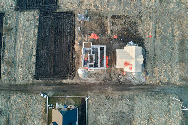 Aerial view of unfinished frame of private house foundation under construction.