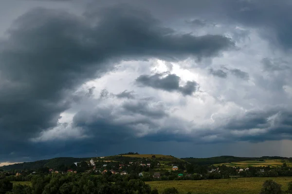 Landscape of dark clouds forming on stormy sky during thunderstorm over rural area — Stock Photo, Image