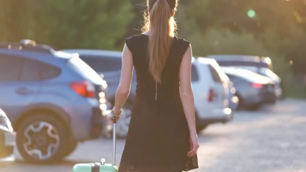 Νεαρή γυναίκα οδηγός βάζει αποσκευές τσάντα βαλίτσα μέσα στο αυτοκίνητό της. Έννοια ταξιδιών και διακοπών — Αρχείο Βίντεο
