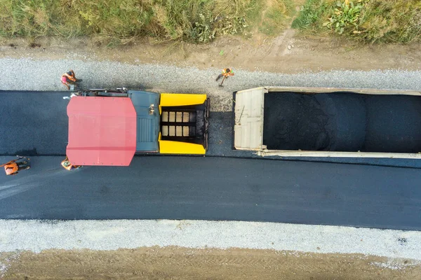 Vista aérea da construção de novas estradas com máquinas de assentamento de asfalto no trabalho — Fotografia de Stock