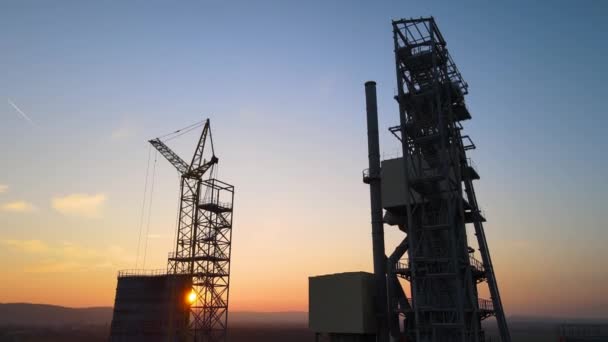 Aerial view of cement factory with high steel plant structure and tower crane at industrial production area. Manufacture and global industry concept — Stock Video