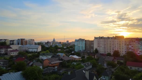 Uitzicht vanuit de lucht op hoogbouw appartementengebouwen, privéhuizen en straten in de woonwijk van de stad 's avonds — Stockvideo