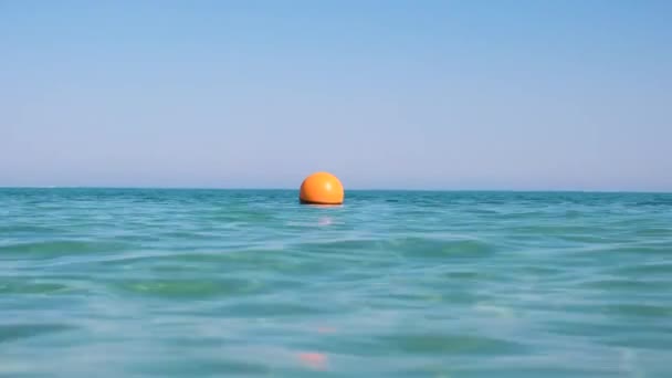 Gele boei drijvend op het zeeoppervlak als marker voor zwembeperking in diep water in tropisch resort. Het begrip "veiligheid van mensenlevens" — Stockvideo