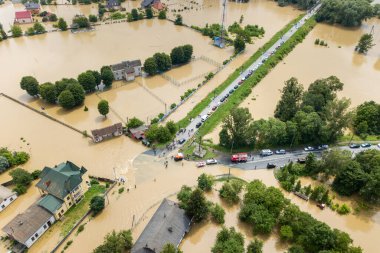 Aerial view of flooded houses and rescue vehicles saving people in Halych town, western Ukraine clipart