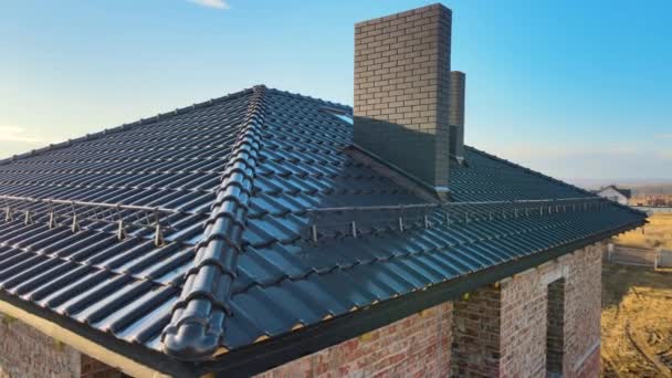 Closeup snow guard for safety in winter on house roof top covered with ceramic shingles. Tiled covering of building — Stock Video