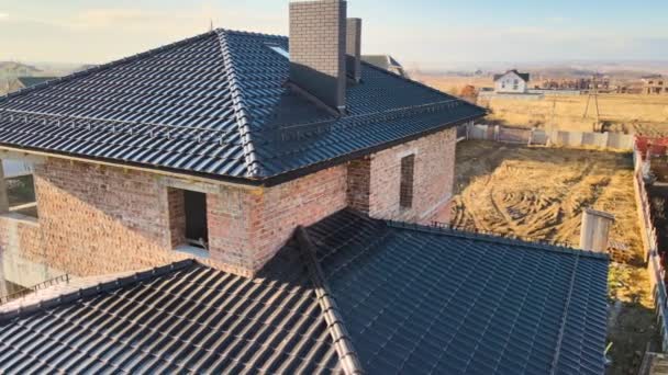 Vista aérea de la azotea de la casa cubierta con tejas de cerámica. Revestimiento de baldosas del edificio en construcción — Vídeo de stock