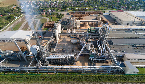 Aerial view of oil and gas refining petrochemical factory with tall refinery plant manufacture structure