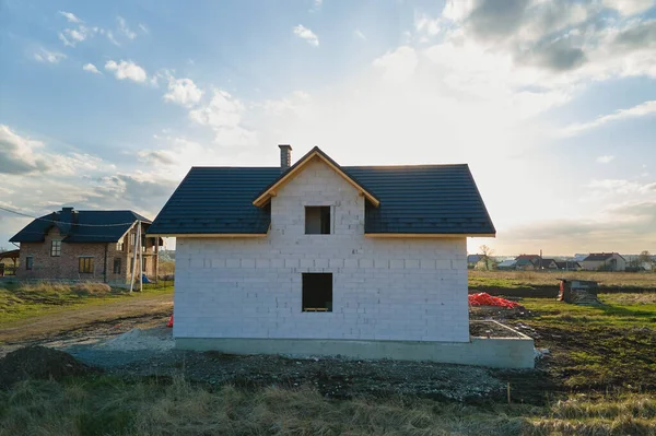 Luftaufnahme eines unfertigen Hauses mit Porenbeton-Leichtbetonwänden und Holzdachrahmen mit Metallziegeln im Bau — Stockfoto