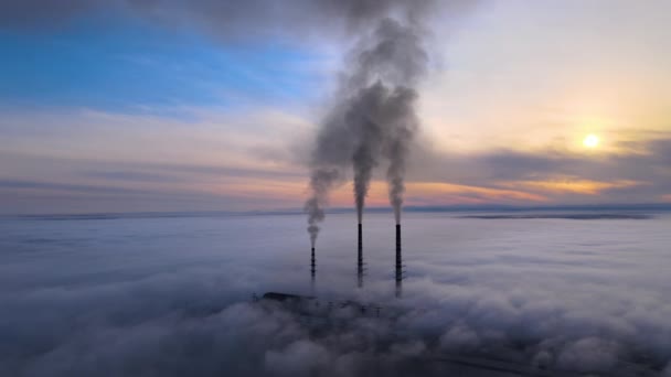 Uitzicht vanuit de lucht op hoge pijpen van kolencentrales met zwarte rook die bij zonsondergang de vervuilende atmosfeer opgaat — Stockvideo