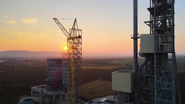 Aerial view of cement factory with high steel plant structure and tower crane at industrial production area. Manufacture and global industry concept — Stock Video