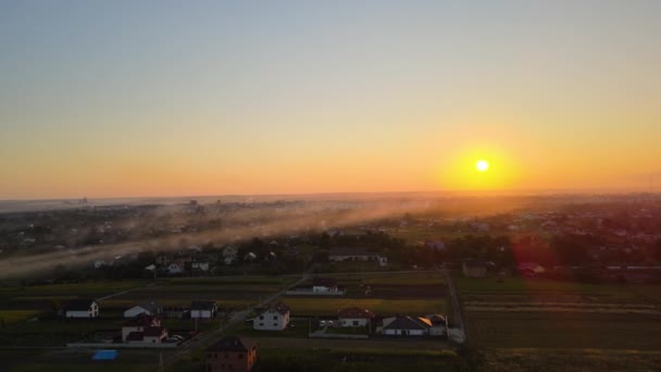 Aerial view of residential houses in suburban rural area at sunset — Stock Video