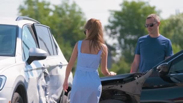 Θυμωμένη γυναίκα και οι οδηγοί των βαριά κατεστραμμένων οχημάτων υποστηρίζοντας ποιος είναι ένοχος σε αυτοκινητιστικό δυστύχημα από την πλευρά του δρόμου. Έννοια οδικής ασφάλειας και ασφάλισης — Αρχείο Βίντεο