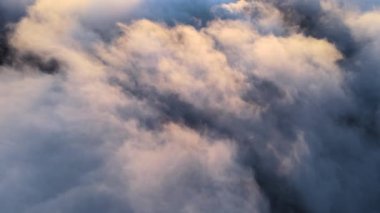 Akşamları havada uçuşan yoğun kümülüs bulutlarının yüksek irtifada havadan görüntülerini göster. Uçak penceresinden gün batımı inanılmaz.