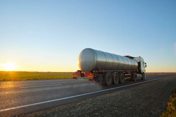 Petrol cargo truck driving on highway hauling oil products. Delivery transportation and logistics concept — Stock Photo, Image