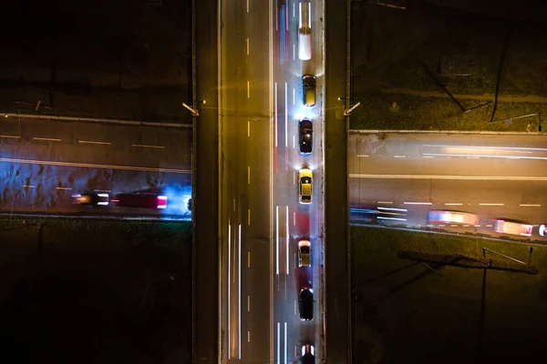 Luftaufnahme einer Straßenkreuzung mit starkem Verkehr in der Nacht. Blick von oben auf den städtischen Verkehr. Rush Hour mit Bewegungsunschärfe von Autofahrerampeln — Stockfoto