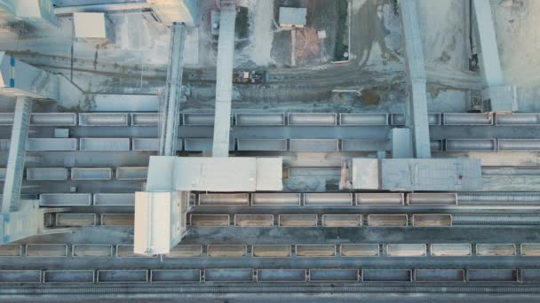 Luchtzicht op goederentrein beladen met verbrijzelde stenen materialen in de mijnbouwfabriek. Spoorwegvervoer van gemalen kalksteenerts — Stockvideo