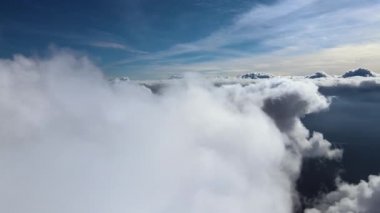 Dünya 'nın yüksek irtifasında, yağmur fırtınasından önce oluşan kabarık kümülüs bulutlarıyla kaplı uçak penceresinden hava görüntüsü