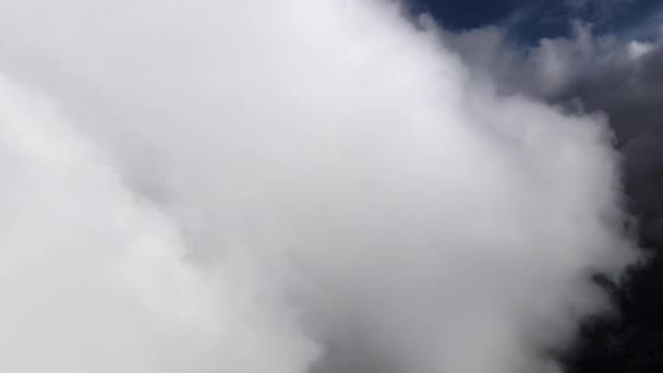 Vzdušný pohled z okna letadla ve vysoké nadmořské výšce země pokrytý nadýchanými kumulativními mraky, které se formovaly před deštěm — Stock video