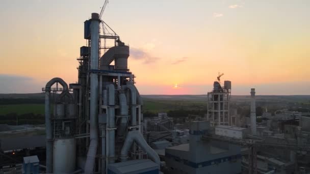 Aerial view of cement factory with high concrete plant structure and tower crane at industrial production area. Manufacture and global industry concept — Stock Video