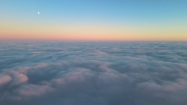 Flygfoto ovanifrån på hög höjd av täta fluffiga cumulusmoln som flyger på kvällen. Fantastisk solnedgång från flygplansfönstrets synvinkel — Stockvideo