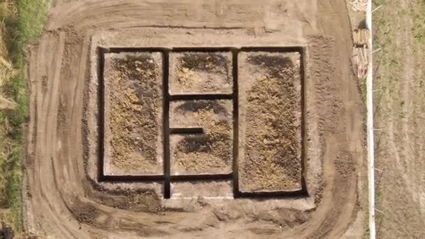 Ausgegrabener Graben für Bauarbeiten an neuem Hausbetonfundament auf Baustelle — Stockvideo