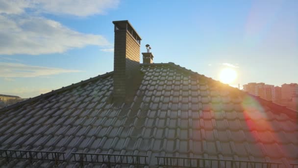 Closeup snow guard for safety in winter on house roof top covered with ceramic shingles. Tiled covering of building — Stock Video