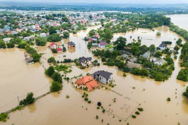 Aerial view of flooded houses with dirty water of Dnister river in Halych town, western Ukraine clipart
