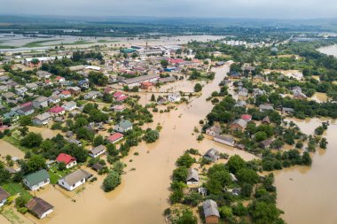 Aerial view of flooded houses with dirty water of Dnister river in Halych town, western Ukraine clipart
