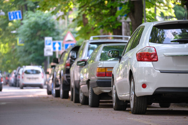 City traffic with cars parked in line on street side