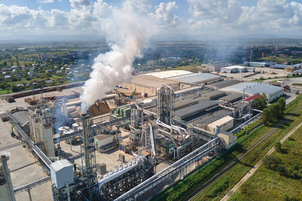 Aerial view of oil and gas refining petrochemical factory with high refinery plant manufacture structure. Global production and manufacturing concept