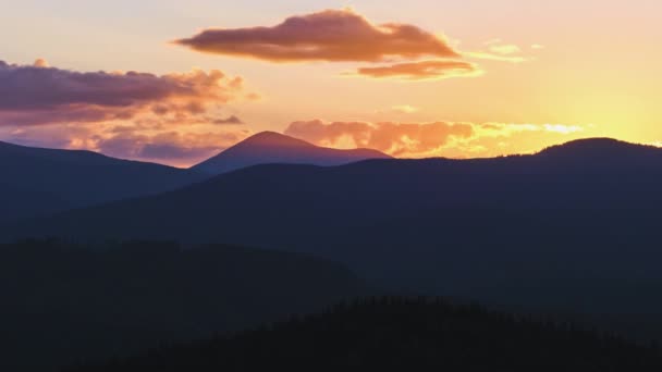 Bela paisagem panorâmica noturna com sol brilhante sobre picos montanhosos distantes ao pôr do sol — Vídeo de Stock